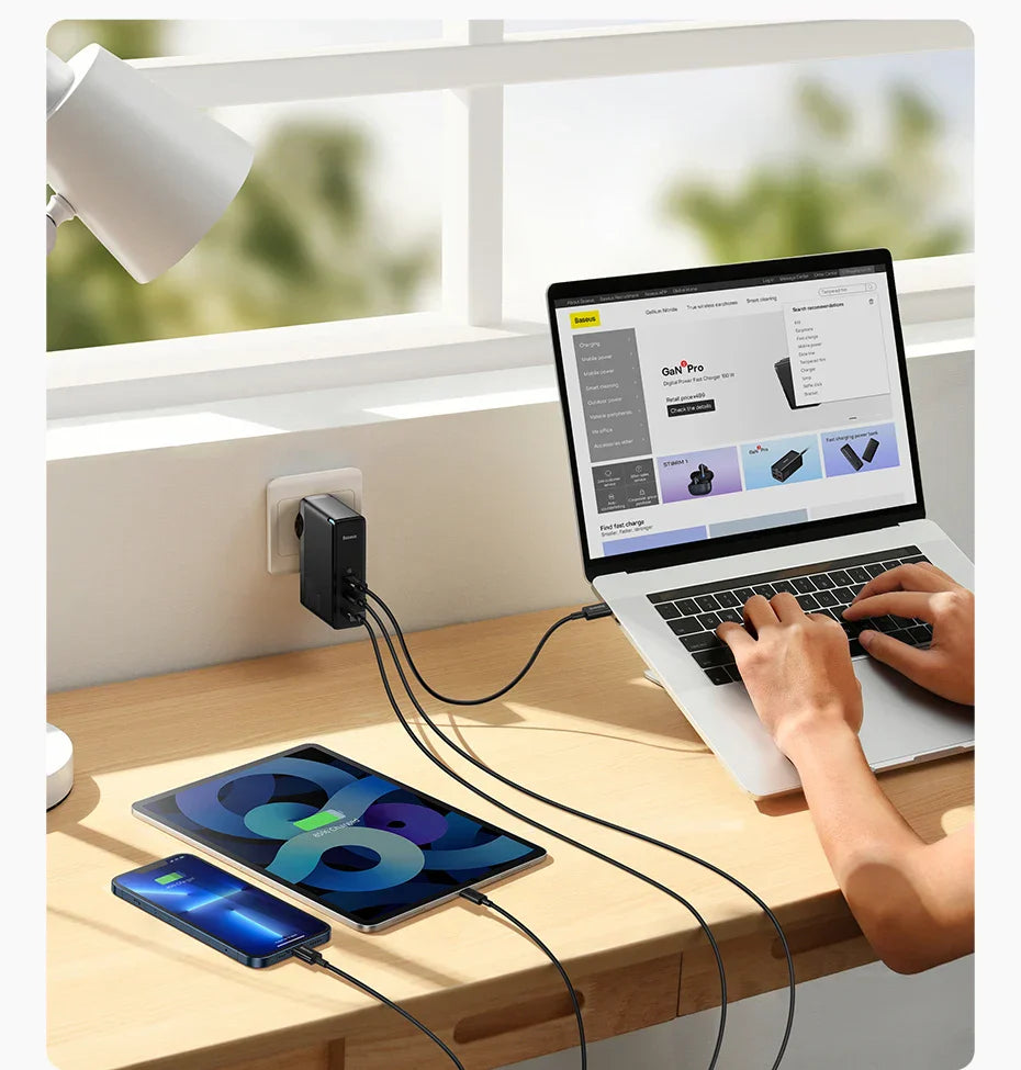 Multi-port USB charger plugged into a wall outlet, powering multiple devices on a desk.
