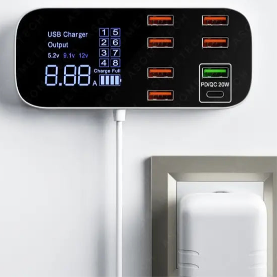 Multi-port USB charging station with digital display showing output voltage and current.