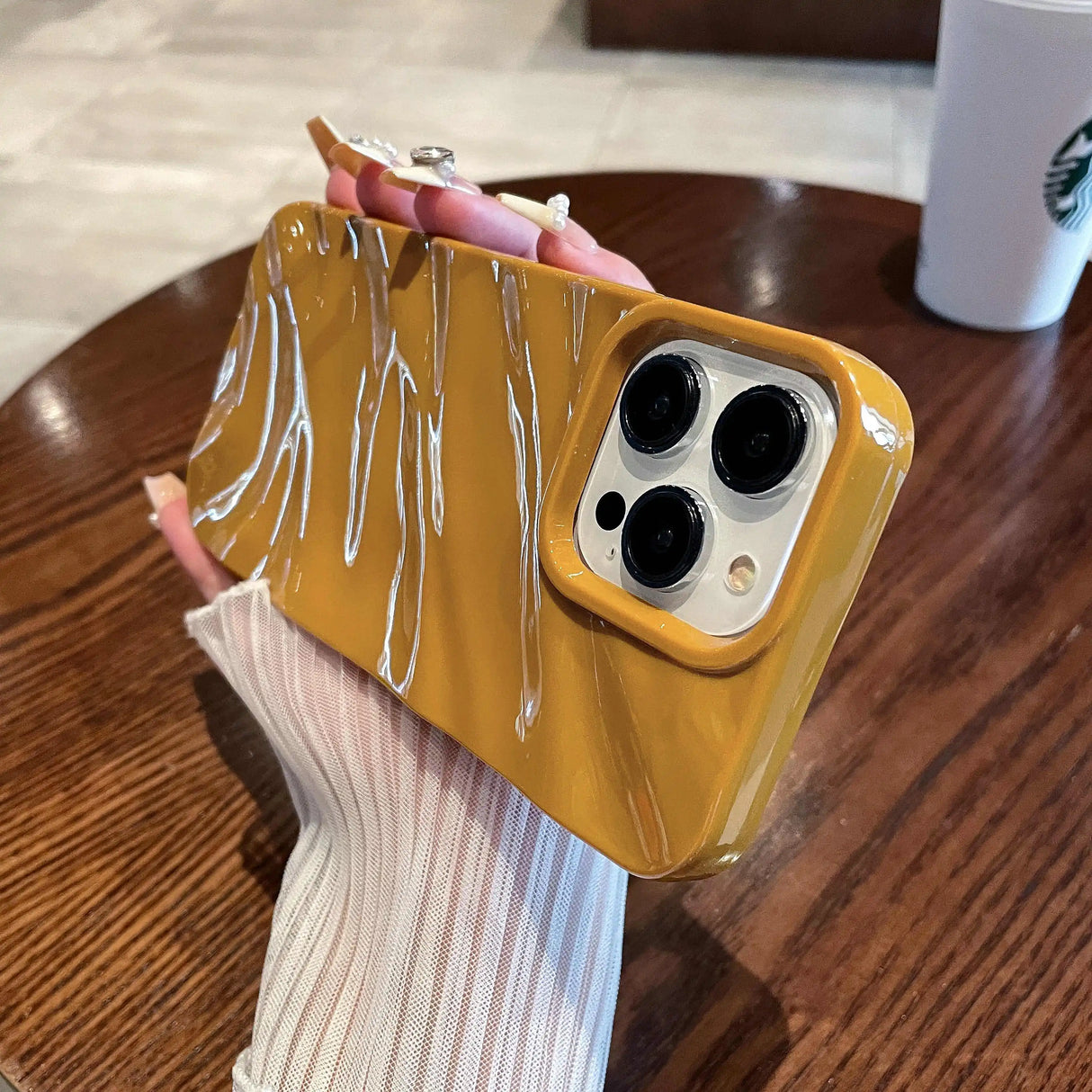 Mustard-yellow phone case with white crackle design.