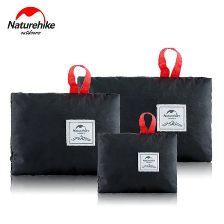 three black bags with red handles and a white label on them