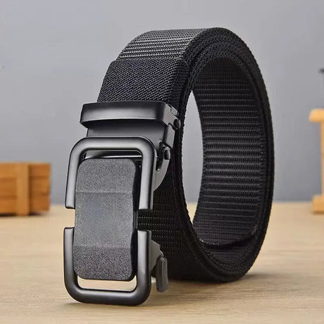 a black belt with a metal buckle on a wooden table