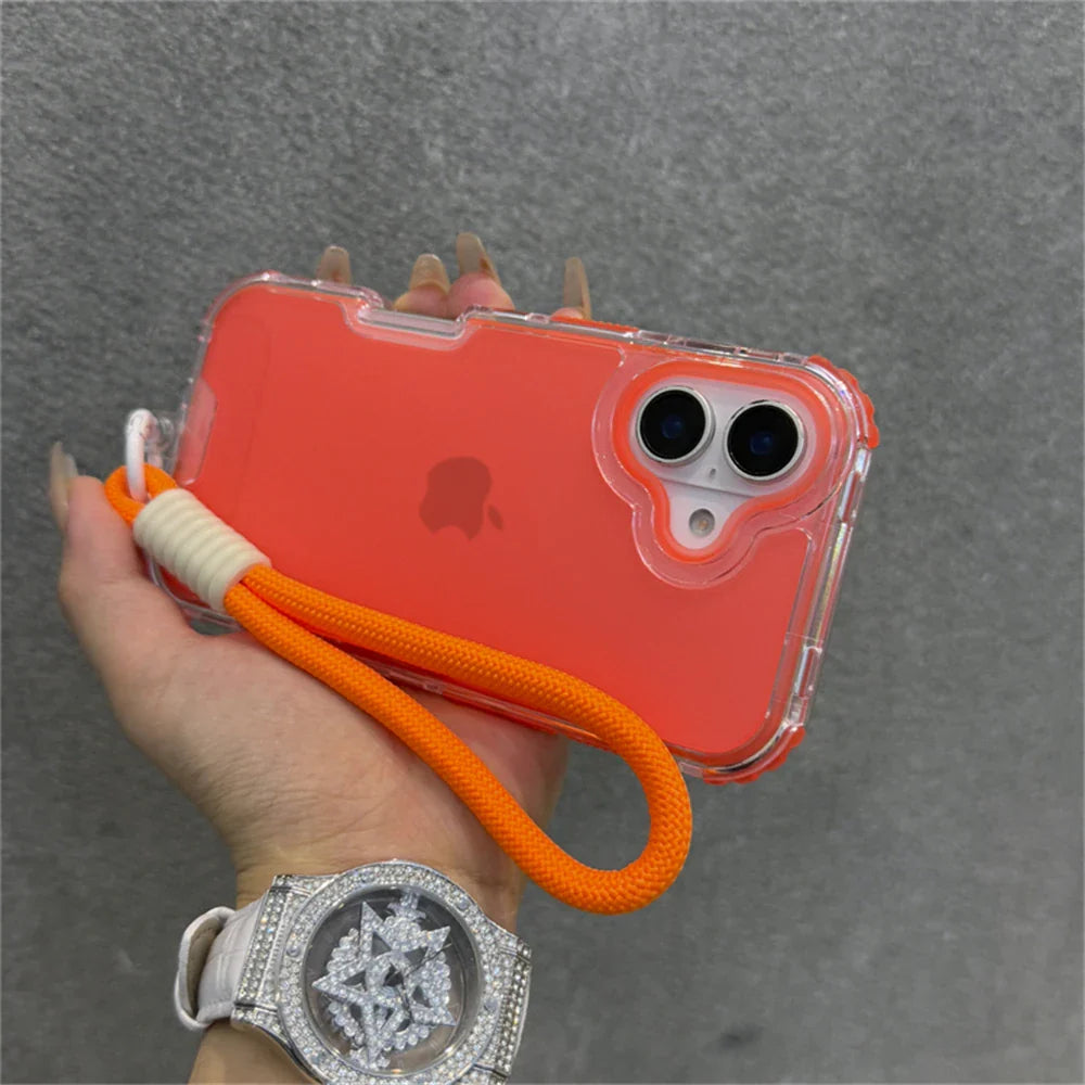 Orange iPhone in a clear case with a wrist strap.