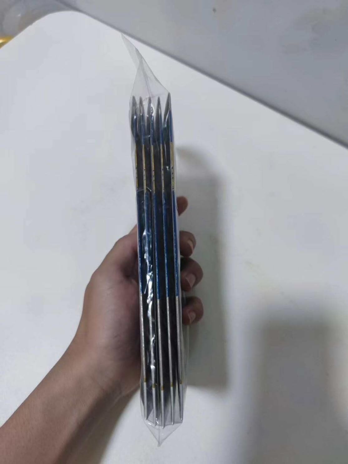 Packaged set of knitting needles.