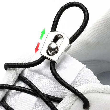 a pair of white sneakers with black laces and a silver shoelacet