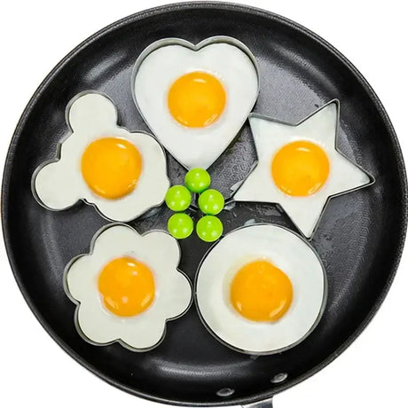 a pan with four eggs in it