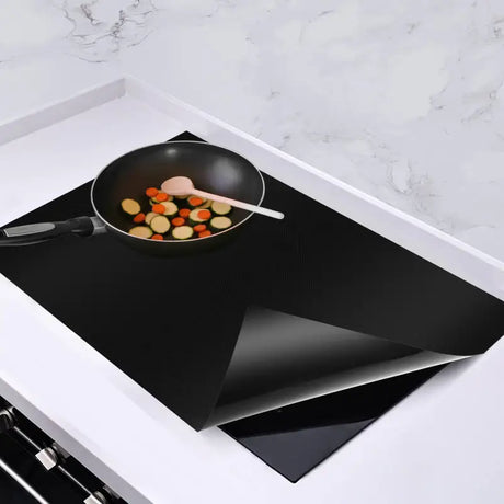 there is a pan with vegetables cooking on a stove top