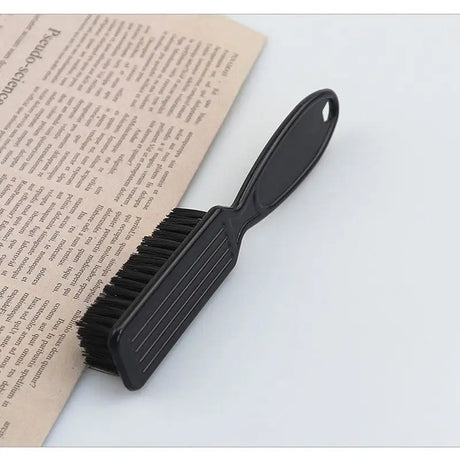 a black brush on top of a book