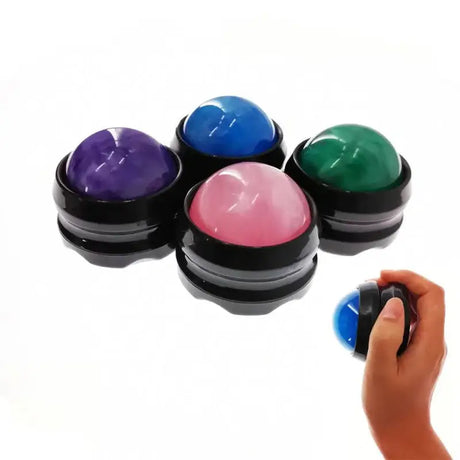 a hand holding a small container with four different colored paints