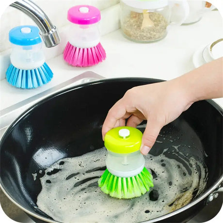 a person cleaning a pan with a brush