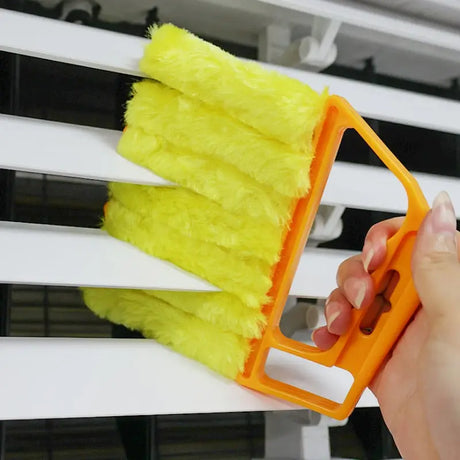 a person is cleaning a window with a brush