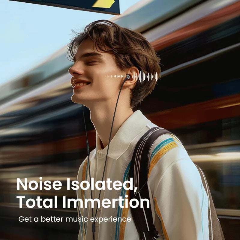 Person wearing earbuds and smiling while standing near a blurred train or subway.