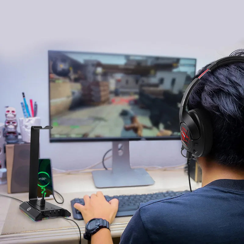 Person playing a first-person shooter video game on a computer setup.