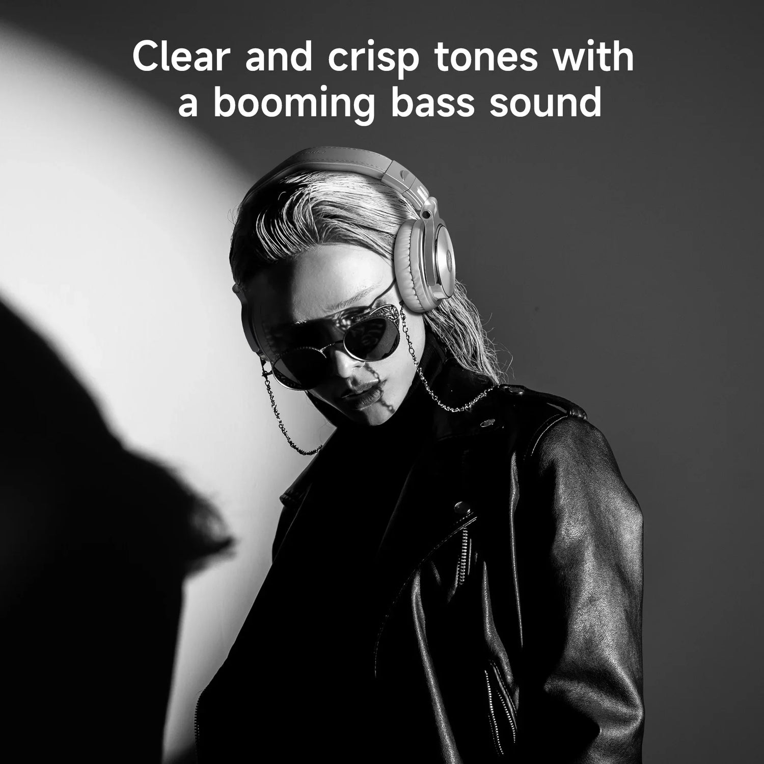Person wearing headphones and sunglasses in a black and white portrait.