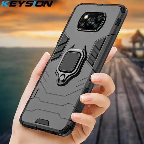 a person holding a black samsung s9 case with a ring holder