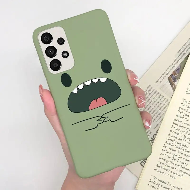 a person holding a book and a phone case