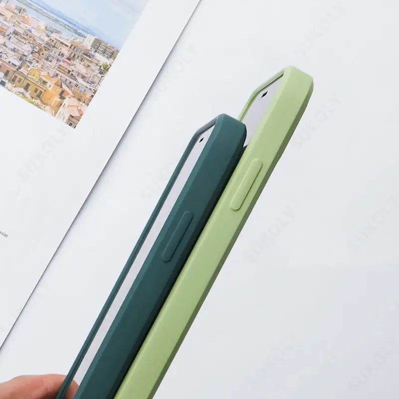 a person holding a green phone case