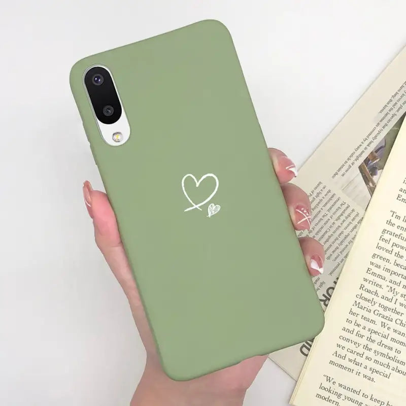 a person holding a green phone case