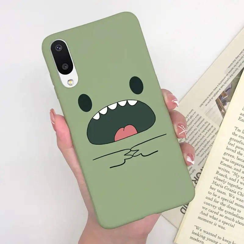 a person holding a book and a phone case