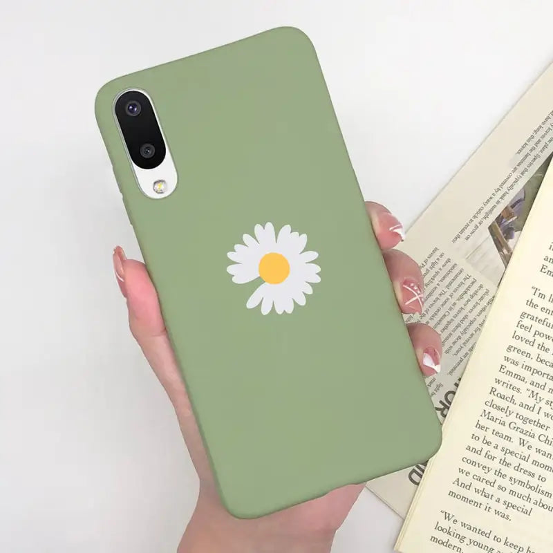 a person holding a book and a phone case