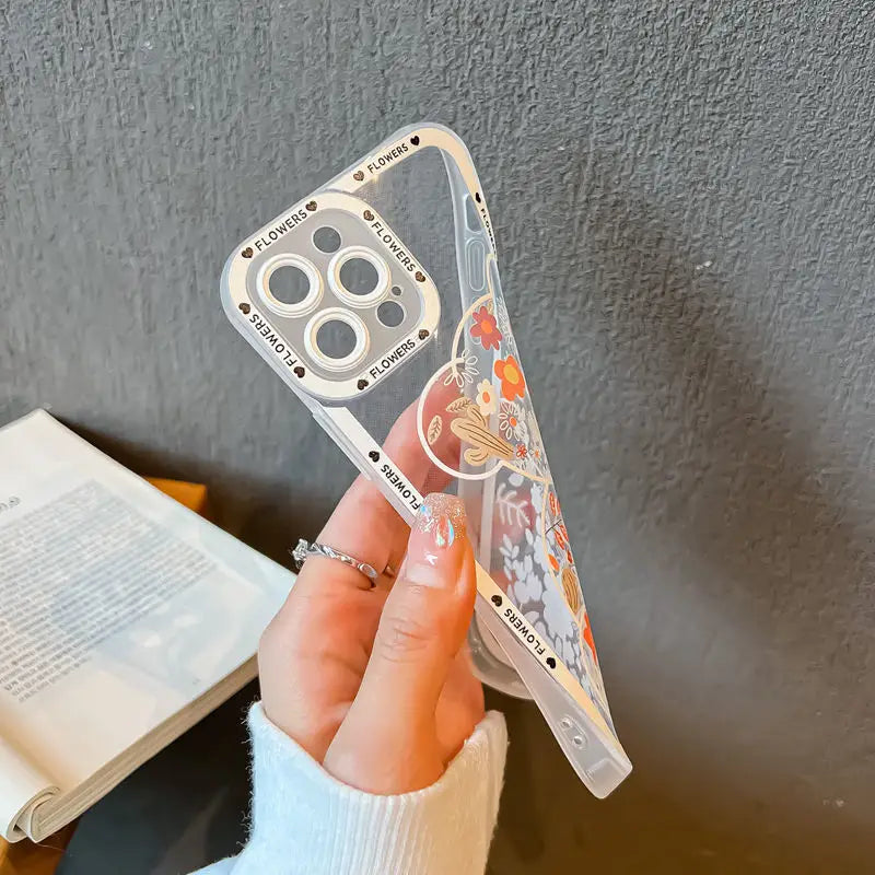 a hand holding a clear phone case with a cartoon character design