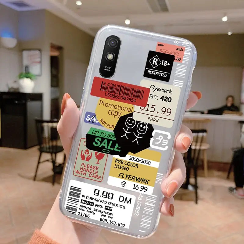 a person holding up a phone case with a sticker on it