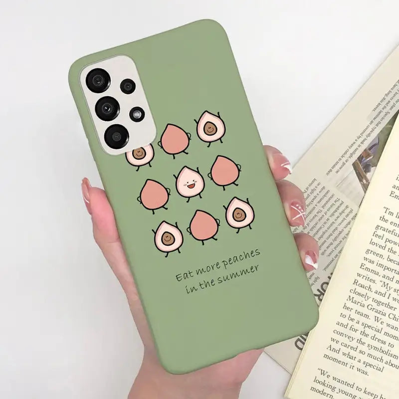 a woman holding a phone case with a green background