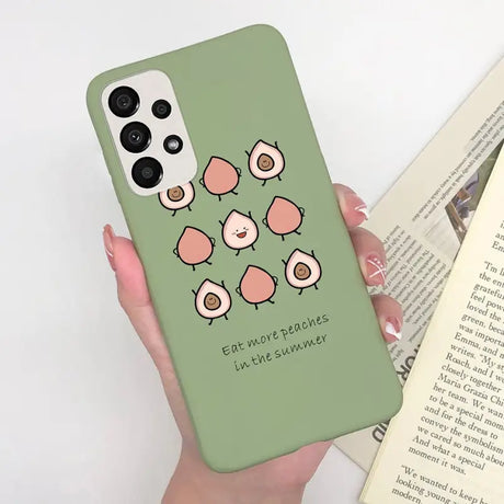 a woman holding a phone case with a green background