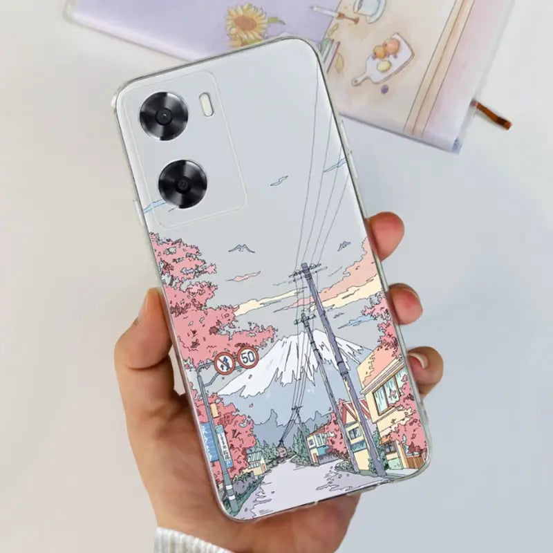 a woman holding a phone case with a drawing of a city