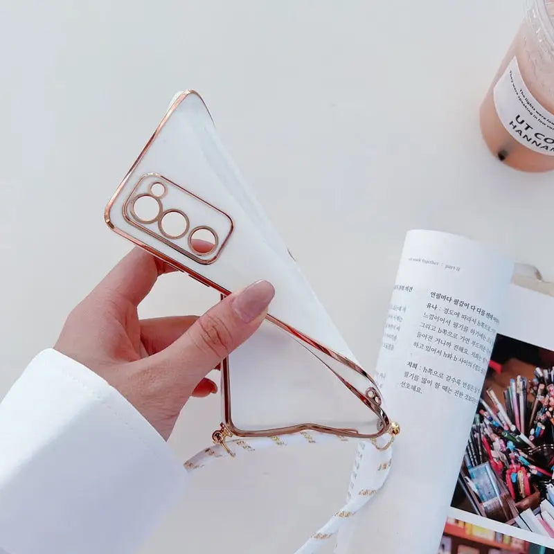 a person holding a phone case with a magazine