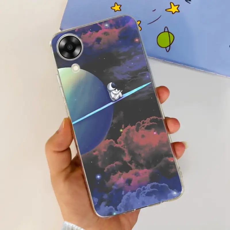a person holding a phone case with a space theme