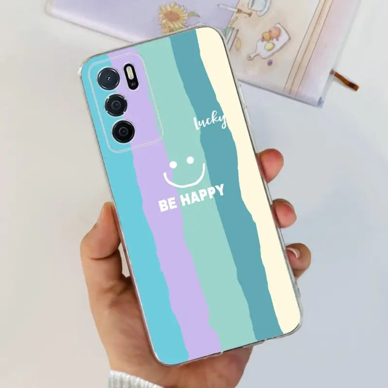 a person holding a phone case with the words be happy