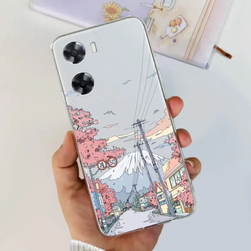 a woman holding a phone case with a drawing of a city
