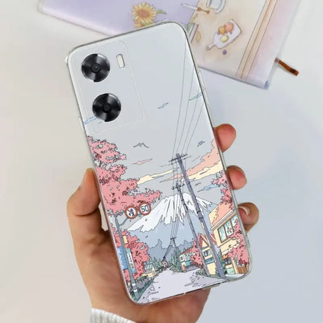 a woman holding a phone case with a drawing of a city