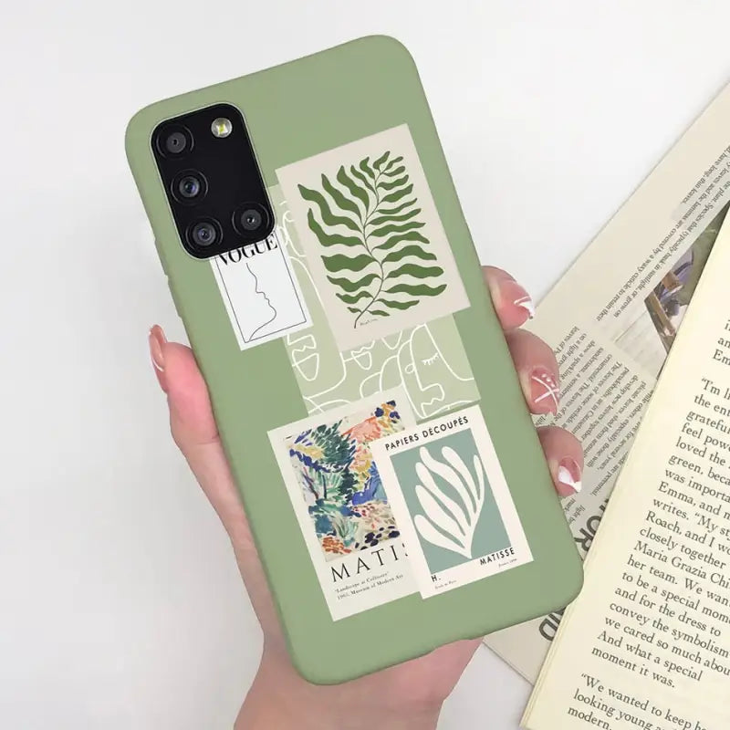 a woman holding a book and a phone case
