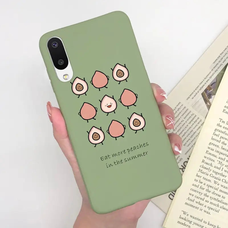 a person holding a phone case with a book