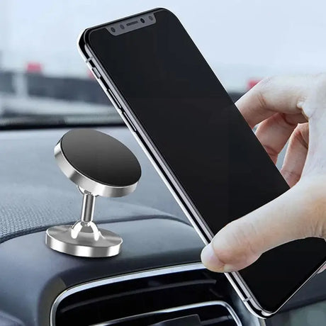 a person holding a phone in their car