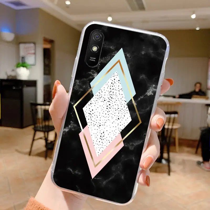 a person holding a phone with a geometric design on it