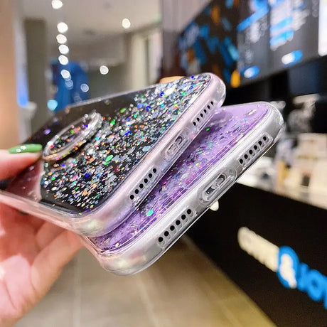 a person holding a phone with glitter on it