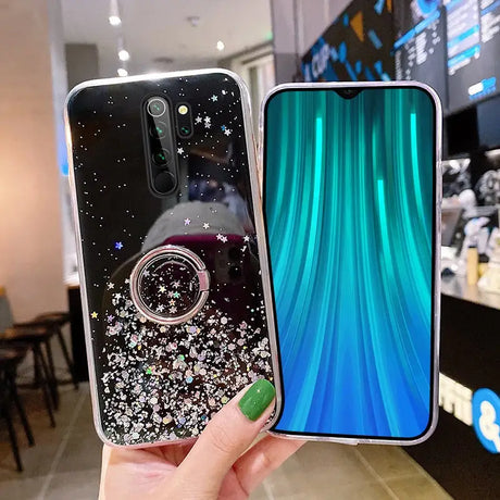 someone holding a phone with a ring case on it