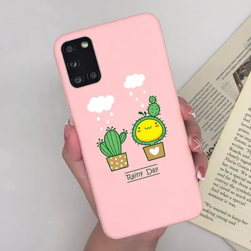 a woman holding a pink phone case with a cactus plant