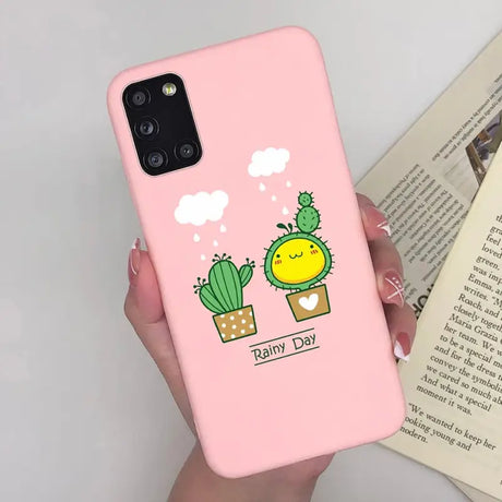 a woman holding a pink phone case with a cactus plant
