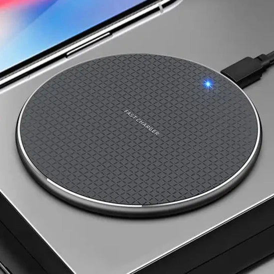 a person holding a wireless device with a charging pad attached to it