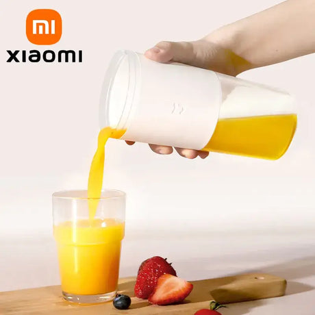 A person pouring orange juice into a glass