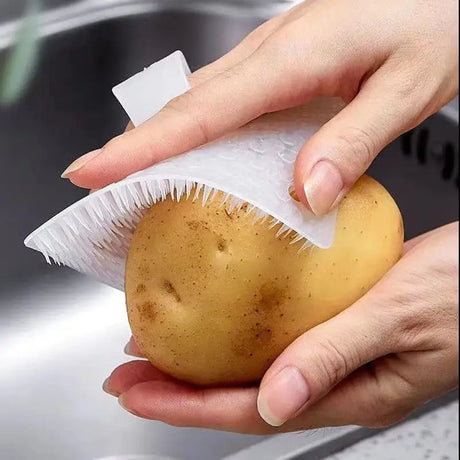 a person is peeling a potato into a plastic bag