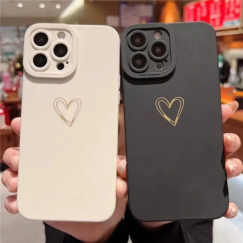 a person holding a phone case with a heart on it