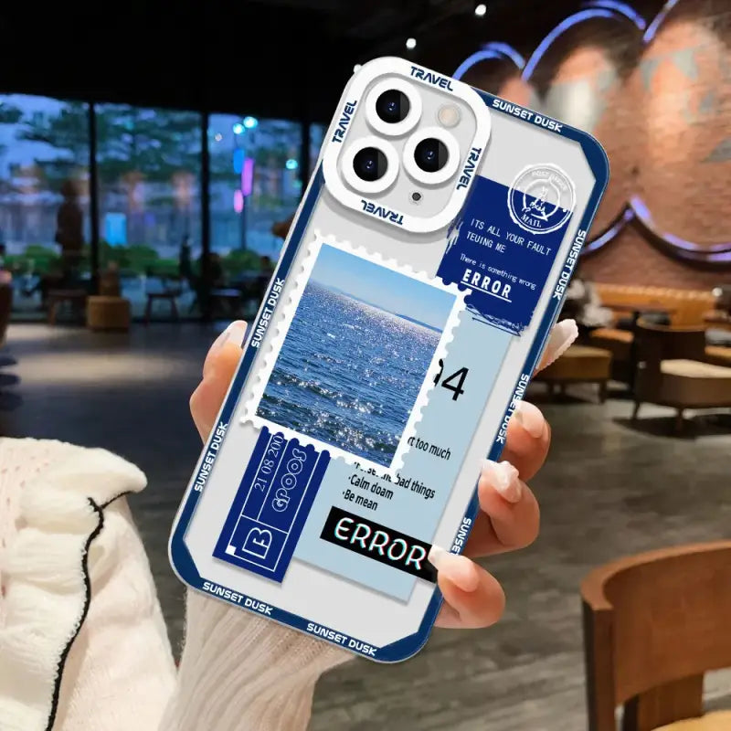 A person holding a phone case with a photo of a beach