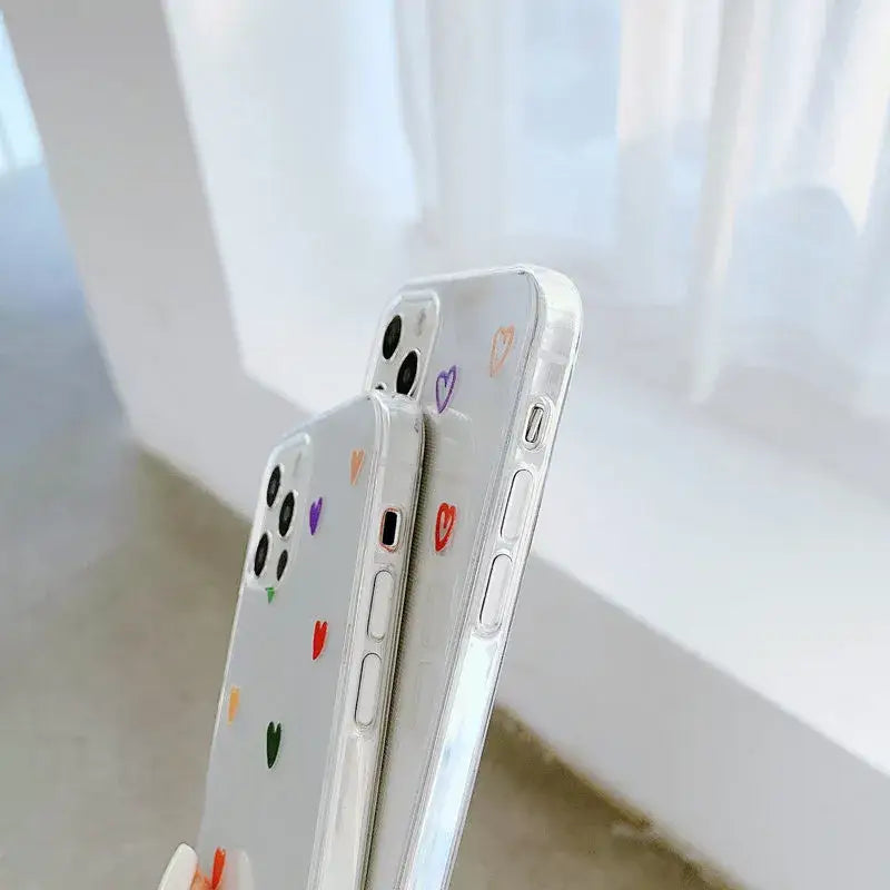 A person holding a phone with a colorful sticker on it