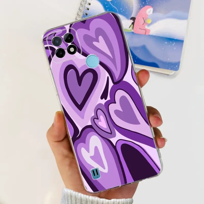 a person holding a purple phone case with a heart design