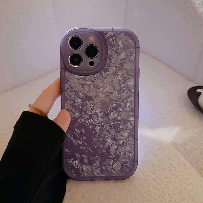 a person holding a purple phone case