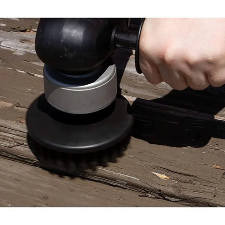 a person using a sander to polish a wood floor